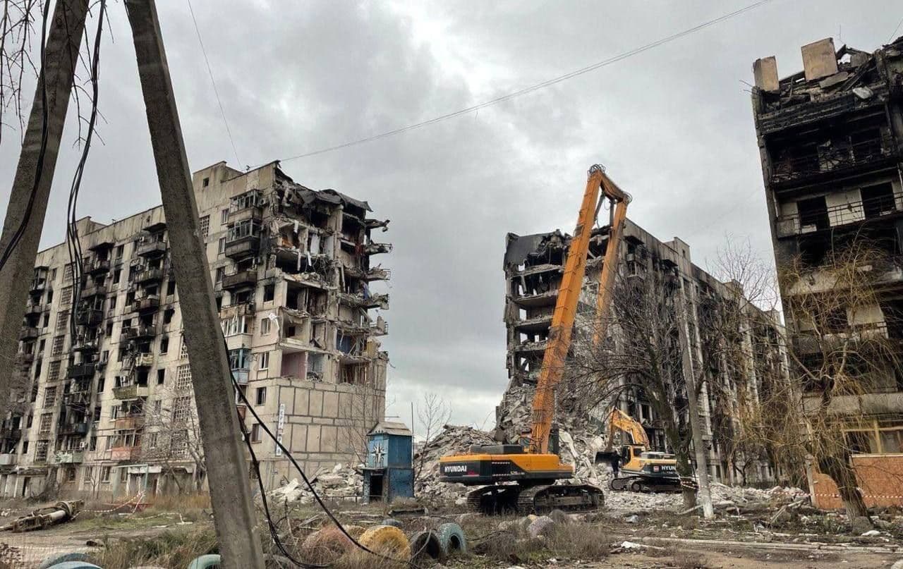 Destroyed apartment blocks being torn down in Mariupol