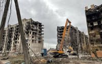 Destroyed apartment blocks being torn down in Mariupol
