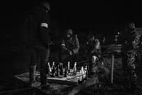 Members the Territorial Defense Forces who guard a large checkpoint briefly played a game of checkers with Molotov cocktails, as seen on the eastern outskirts of Kyiv, Ukraine, on March 5. With few vehicles passing because of the nighttime curfew, Territorial Defense members can have a moment of quiet while remaining on high alert for any suspicious activity.