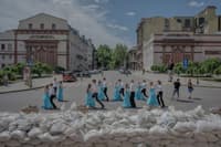 School graduates dance by sandbags protecting the front of the Opera Theater for a video to be posted online, in Odesa, Ukraine, on June 15. 