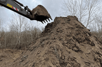 The sand and fuel oil mixture being dumped at a 'temporary storage site' near the village of Voskresensky.