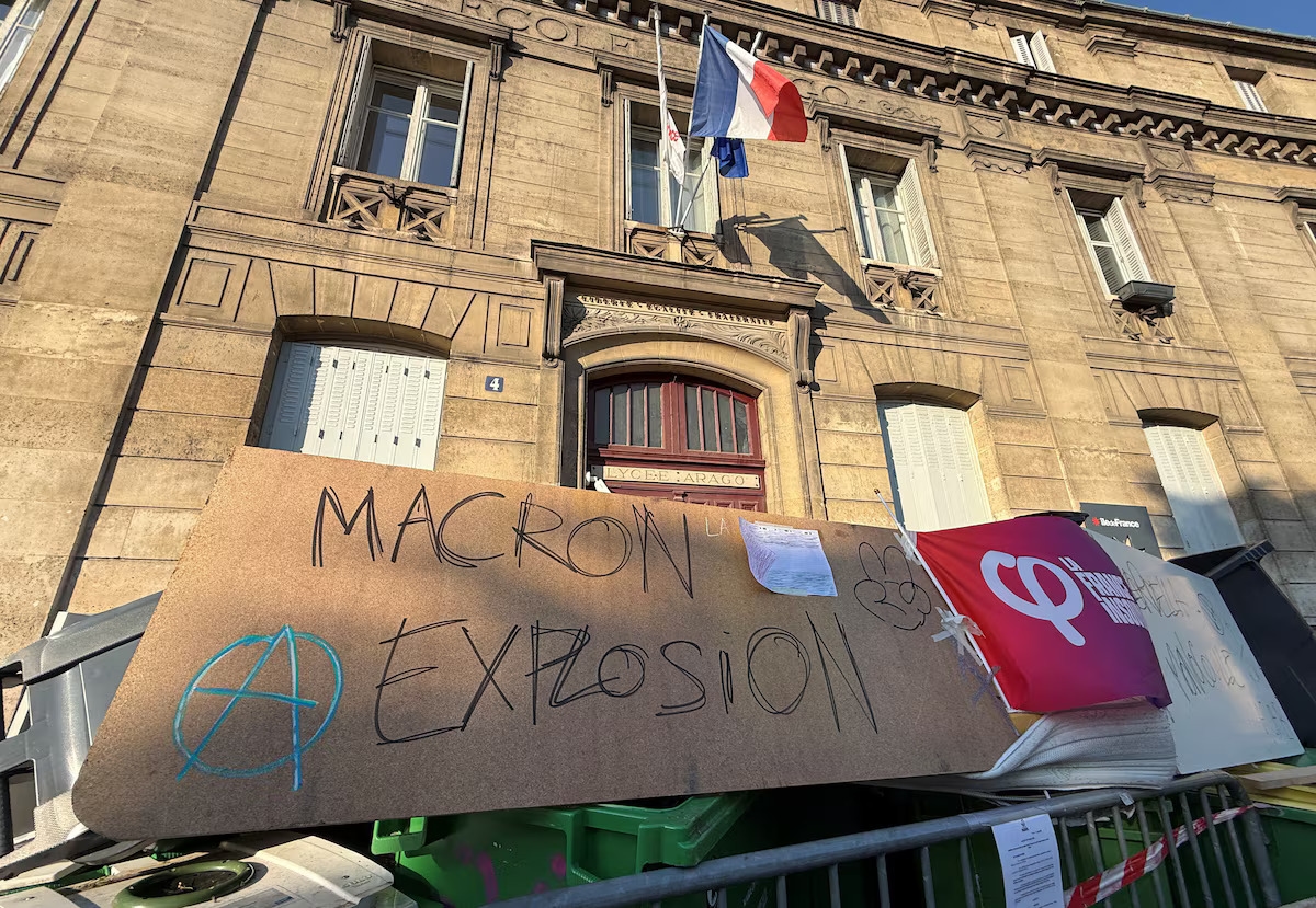 Плакат с надписью Macron explosion у заблокированного лицеистами входа в лицей Араго в Париже