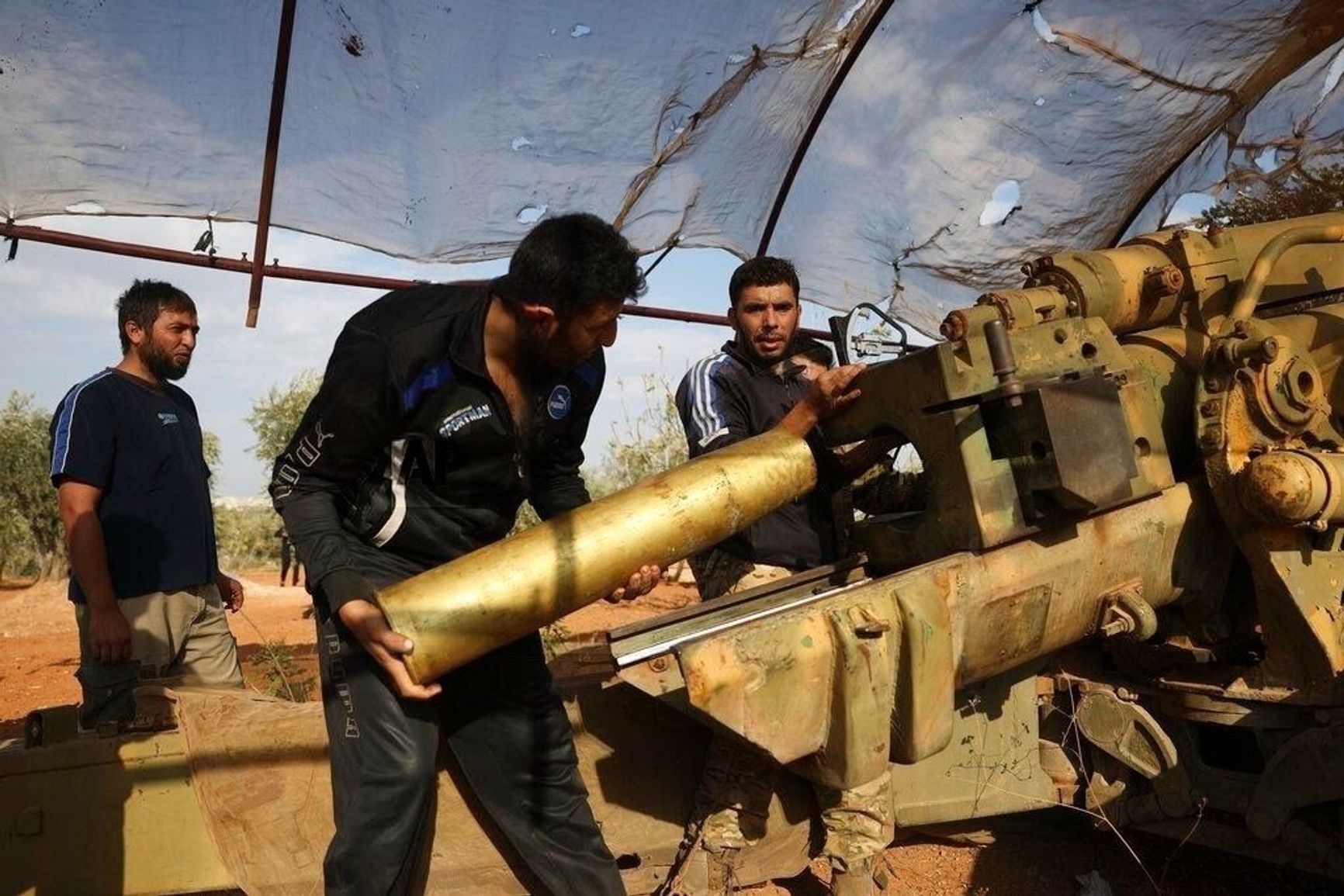 A fighter from Faylaq al-Sham loading artillery shells in 2020.