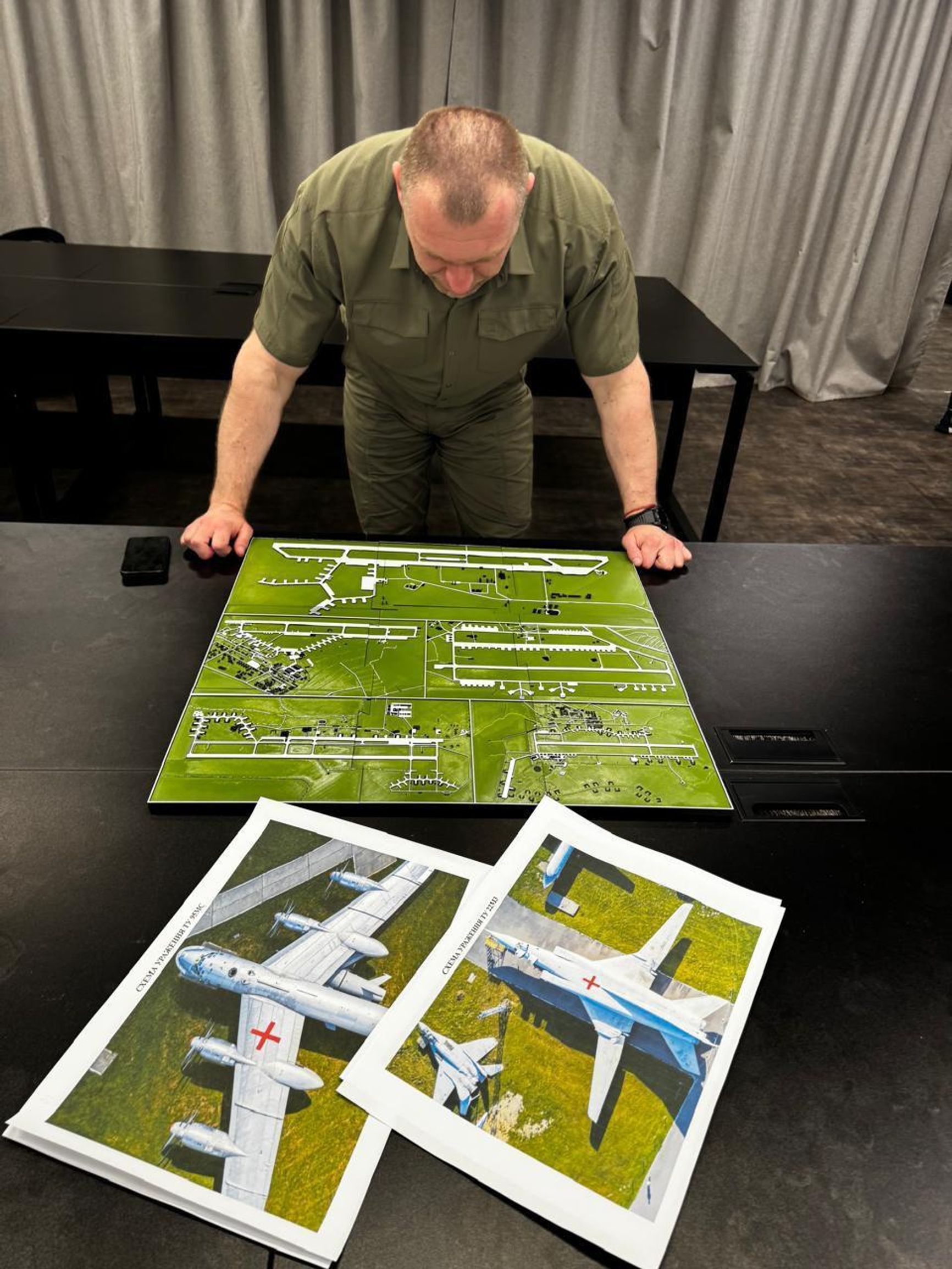 SBU head Vasyl Maliuk looks at maps of the Russian air bases targeted in Operation Spiderweb.