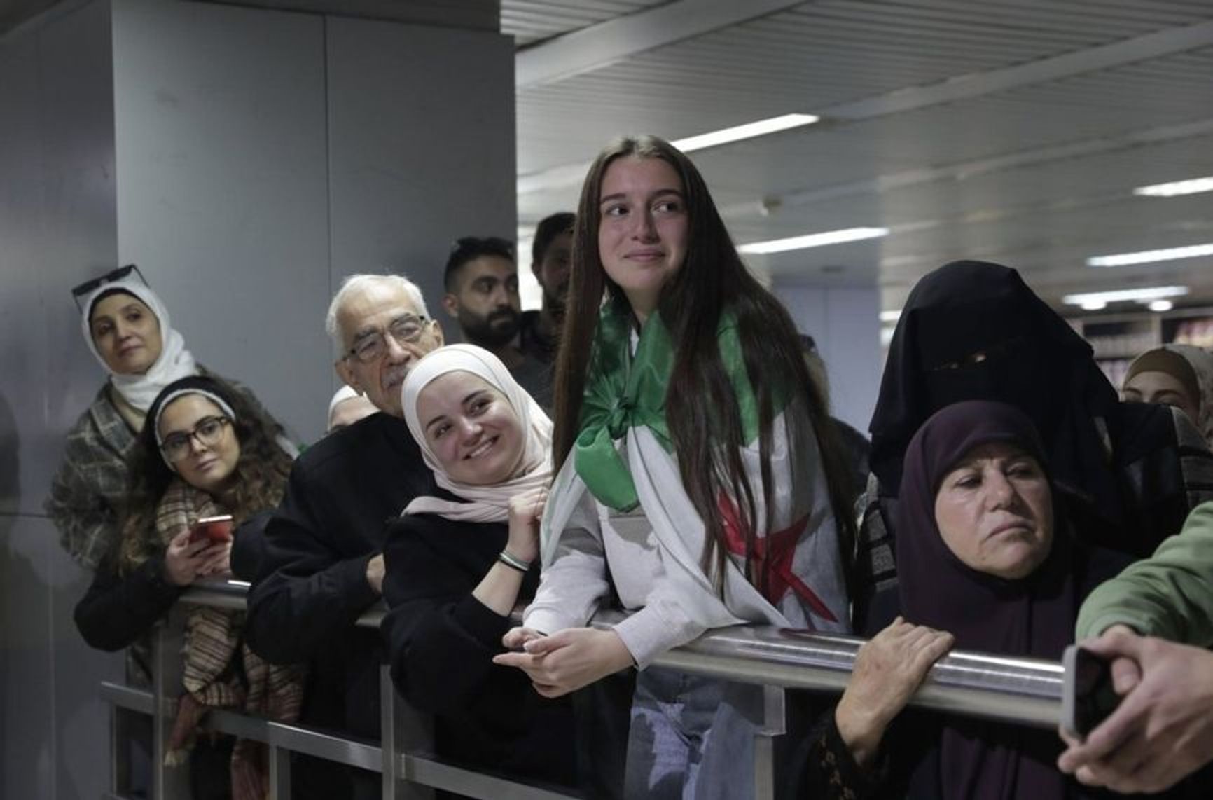 Syrians at Damascus Airport greet relatives returning from abroad on the first commercial flight, Jan. 7, 2025.