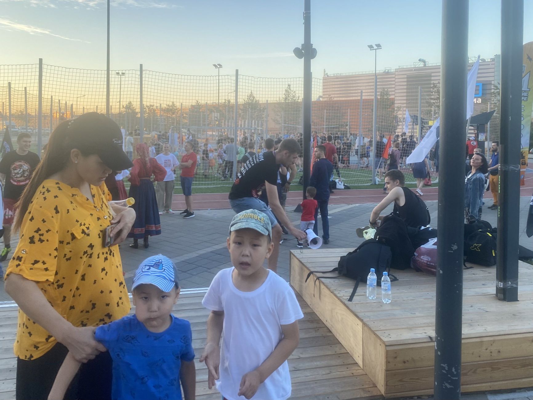 A woman leading children away from a Russian nationalist event