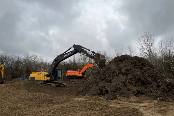 The sand and fuel oil mixture being dumped at a 'temporary storage site' near the village of Voskresensky.