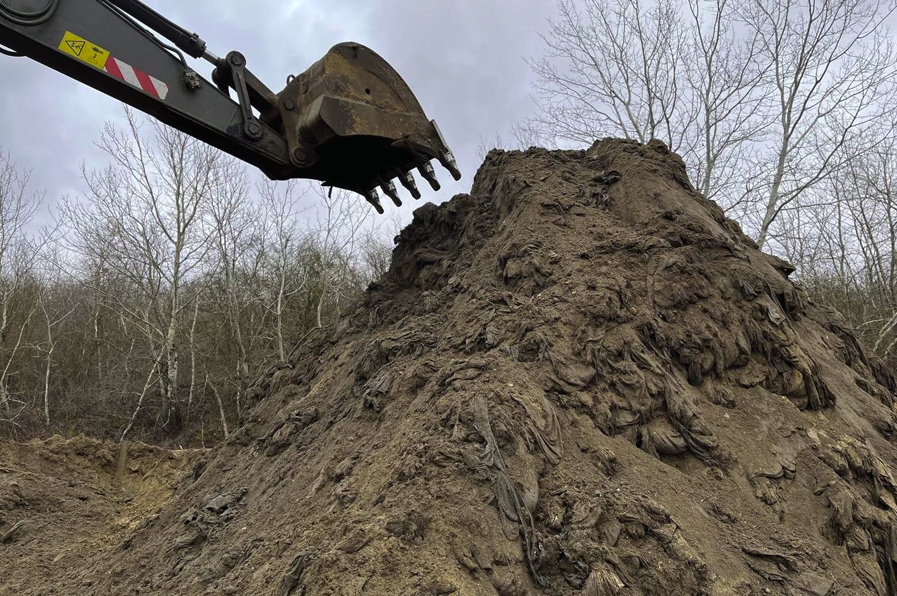 The sand and fuel oil mixture being dumped at a 'temporary storage site' near the village of Voskresensky.