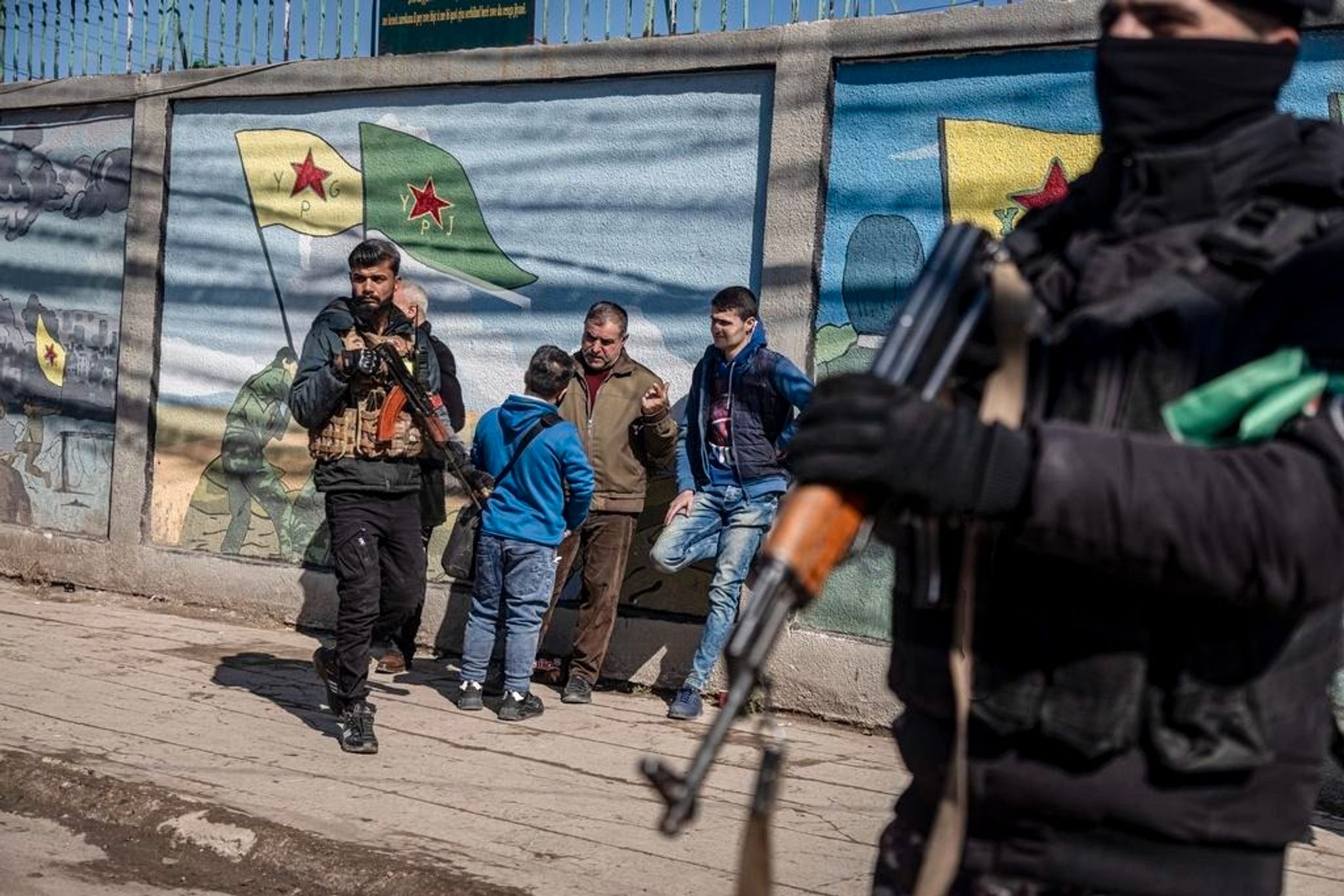 Kurdish fighters patrol an area in Qamishli, northeastern Syria.