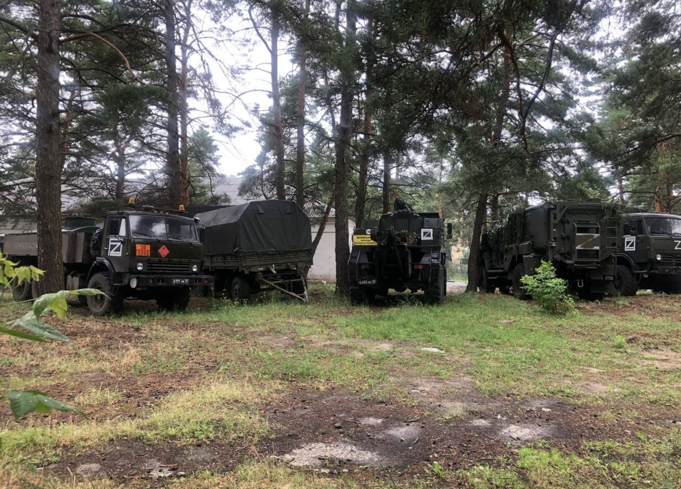 Military vehicles are parked in front of the Shebekino central district hospital