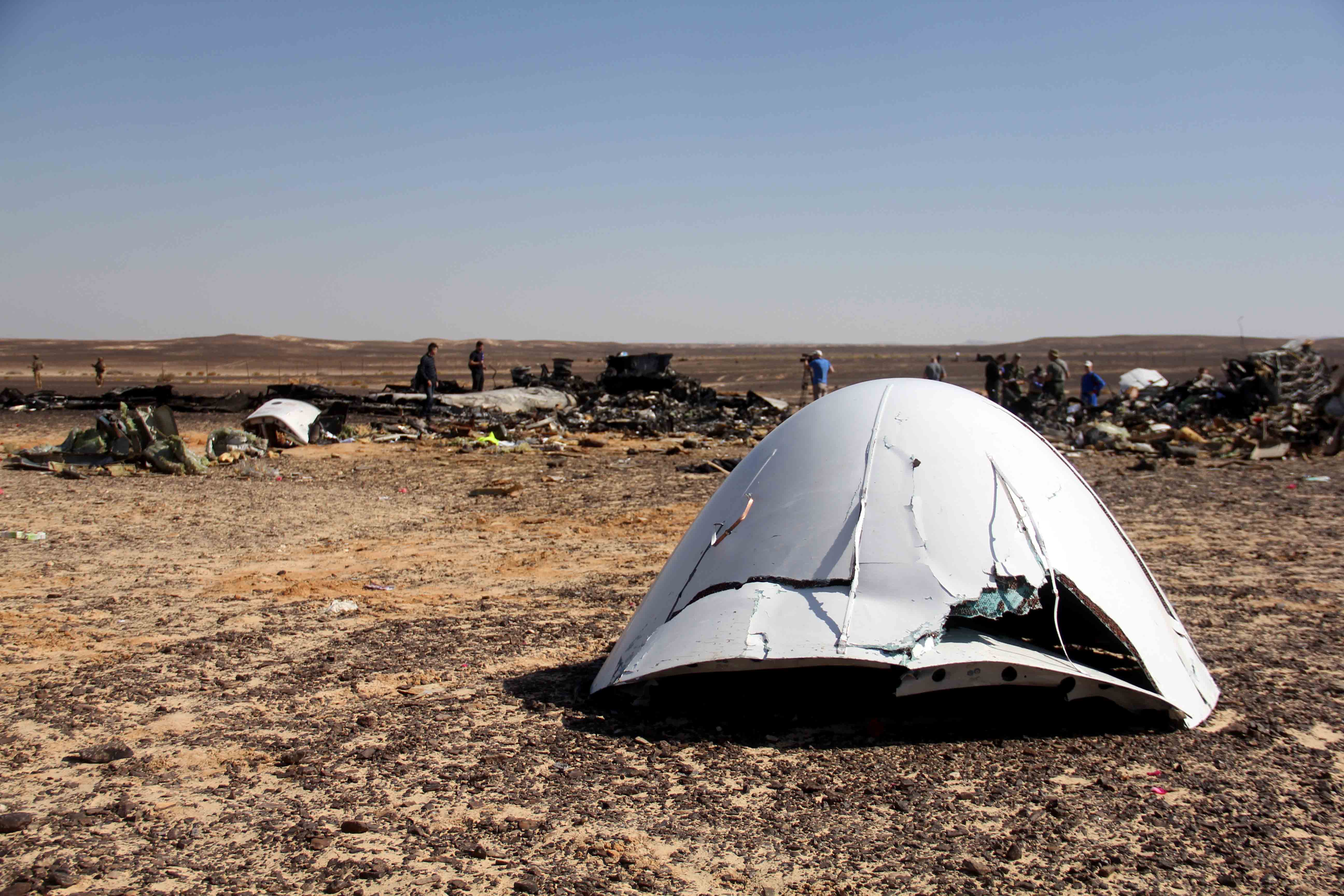 Debris of a Russian airplane is seen at the site a day after the passenger jet bound for St. Petersburg, Russia, crashed in Hassana, Egypt, on Sunday, Nov. 1, 2015. The Metrojet plane, bound for St. Petersburg in Russia, crashed 23 minutes after it took off from Egypt